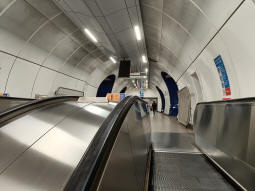 From the top of the escalators down to the DLR from the Northern line