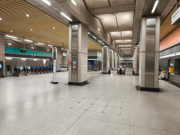 The ticket hall with escalators down to the platforms both straight ahead and behind