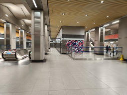 The ticket hall with one of the sets of escalators to the platforms on the left and the escalators to the street in the background on the right