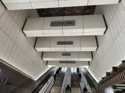 Looking up to the Davies Street ticket hall. Escalators down to the Elizabeth line platforms are behind, a tunnel to the Underground is to the right
