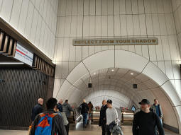 The escalators down to the Elizabeth line platforms coming from Davies Street (up escalators behind) or the Underground (through tunnel to left)