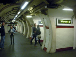 The lower lift lobby. Light-up signs indicate the next lift