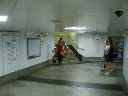 Stairs to the District and Circle line eastbound platform with the top of the escalator from the southbound Northern line platform off to the right