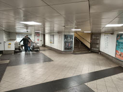 Escalator to the Northern line northbound platform on the left, stairs up to the District and Circle line westbound platform on the right