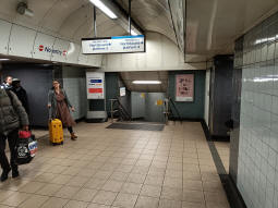 Looking towards the spiral stairs down to the southbound-to-northbound Victoria and Northern line Bank branch interchange passage from near the escalators up to the ticket hall