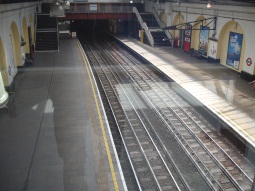 Looking down through glass to the platforms from the corridor to the shopping centre's car park