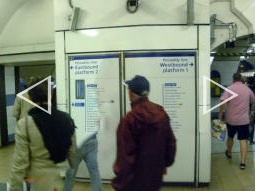 Auto-stitched (hence the legs on their own) panorama of the entrance to the Piccadilly line platforms from the escalators from the ticket hall