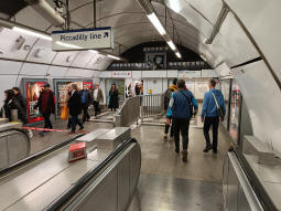 At the bottom of the escalators to the way out and the Central line from the Piccadilly line