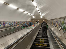 Looking up escalators to the part-time Central line ticket hall from the Central line itself