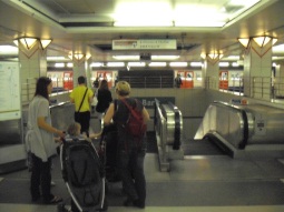 Escalators (and thin stairway) to DLR at Bank, with platforms in background (westbound nearest)