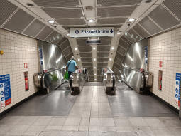 The escalators and stairs down to the tunnel to the Elizabeth line from between the Bakerloo line platforms