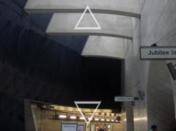 At the top of the lower bank of escalators