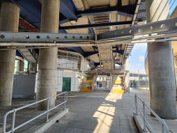 The ticketing area with the upper staircase and the lift near the centre of the shot going up to the platform for trains to Lewisham and Canary Wharf