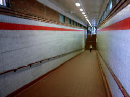 Looking down the ramp to the underpass coming from Snakes Lane East -- the ticket hall on this side can be seen up the stairs